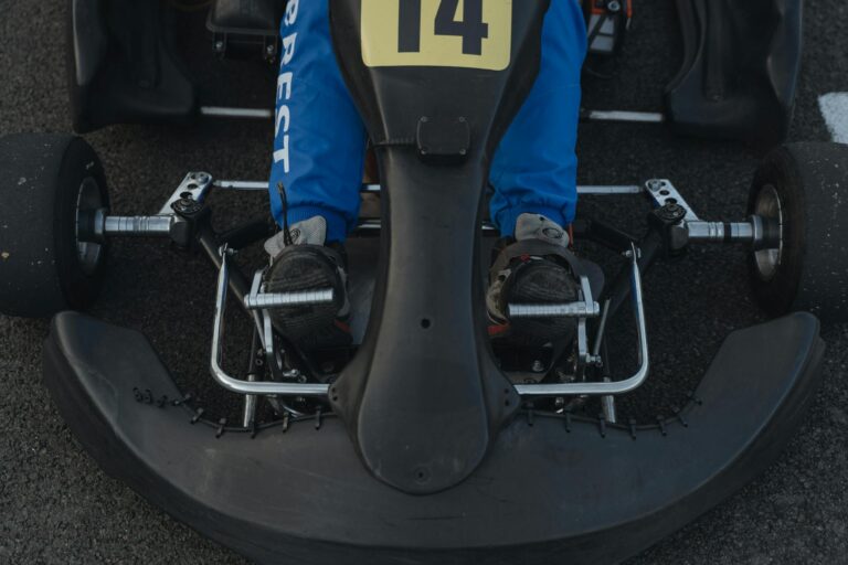 A detailed view of a go-kart's pedals, highlighting the accelerator and brake setup.